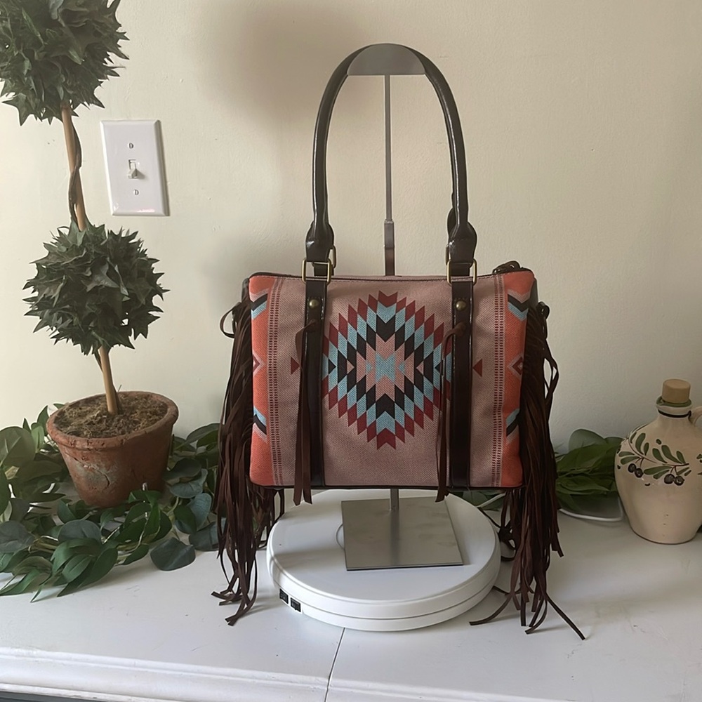 Navajo print fringe bag stylish, lots of versatility. Brown faux leather straps